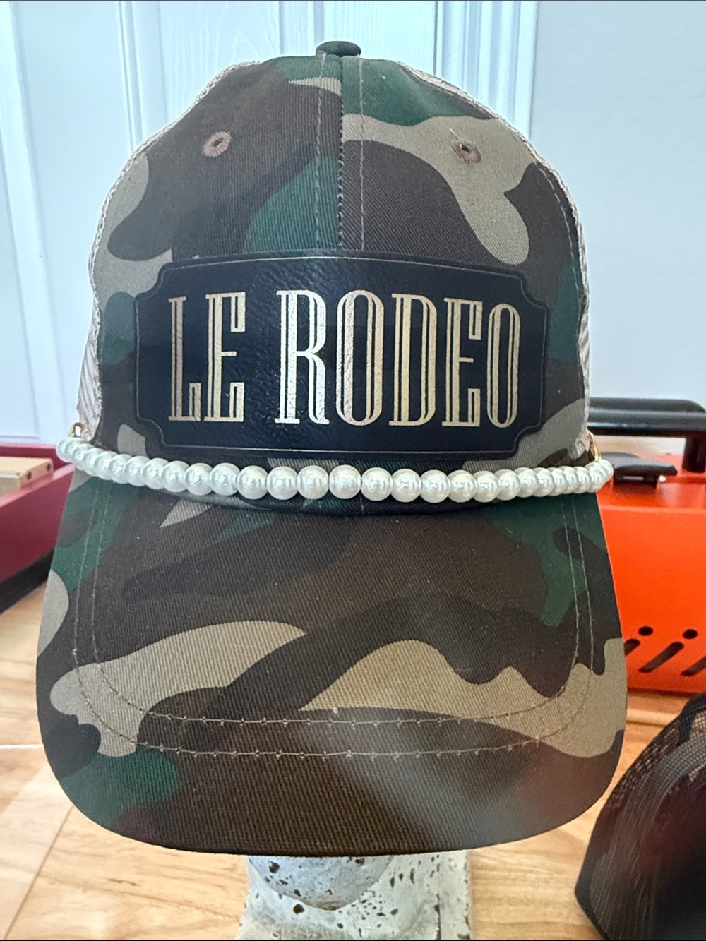 Le Rodeo patch in black and gold Camouflage Pearl hat band Trucker Hat